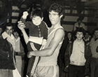 Basquetbolista con niño en brazos